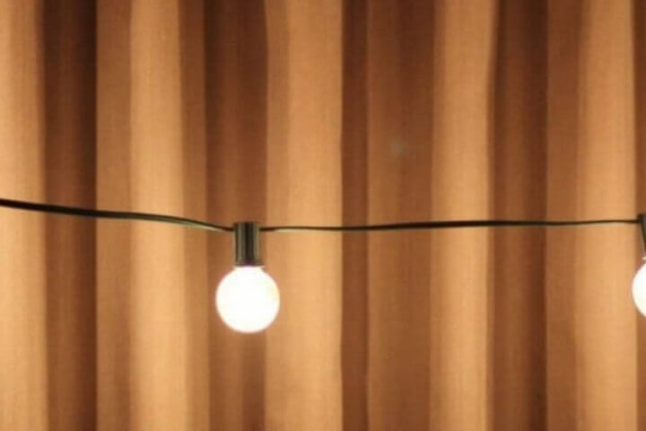 patio lights in front of a curtain