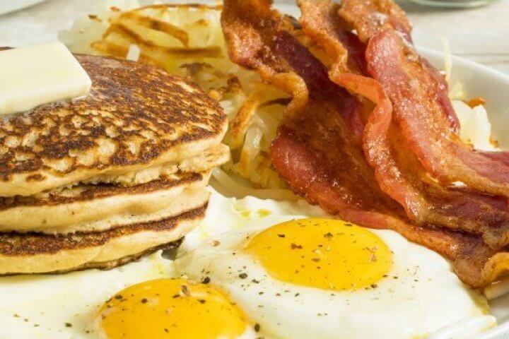 Breakfast of Eggs, Bacon, Pancakes, Toast, Orange Juice